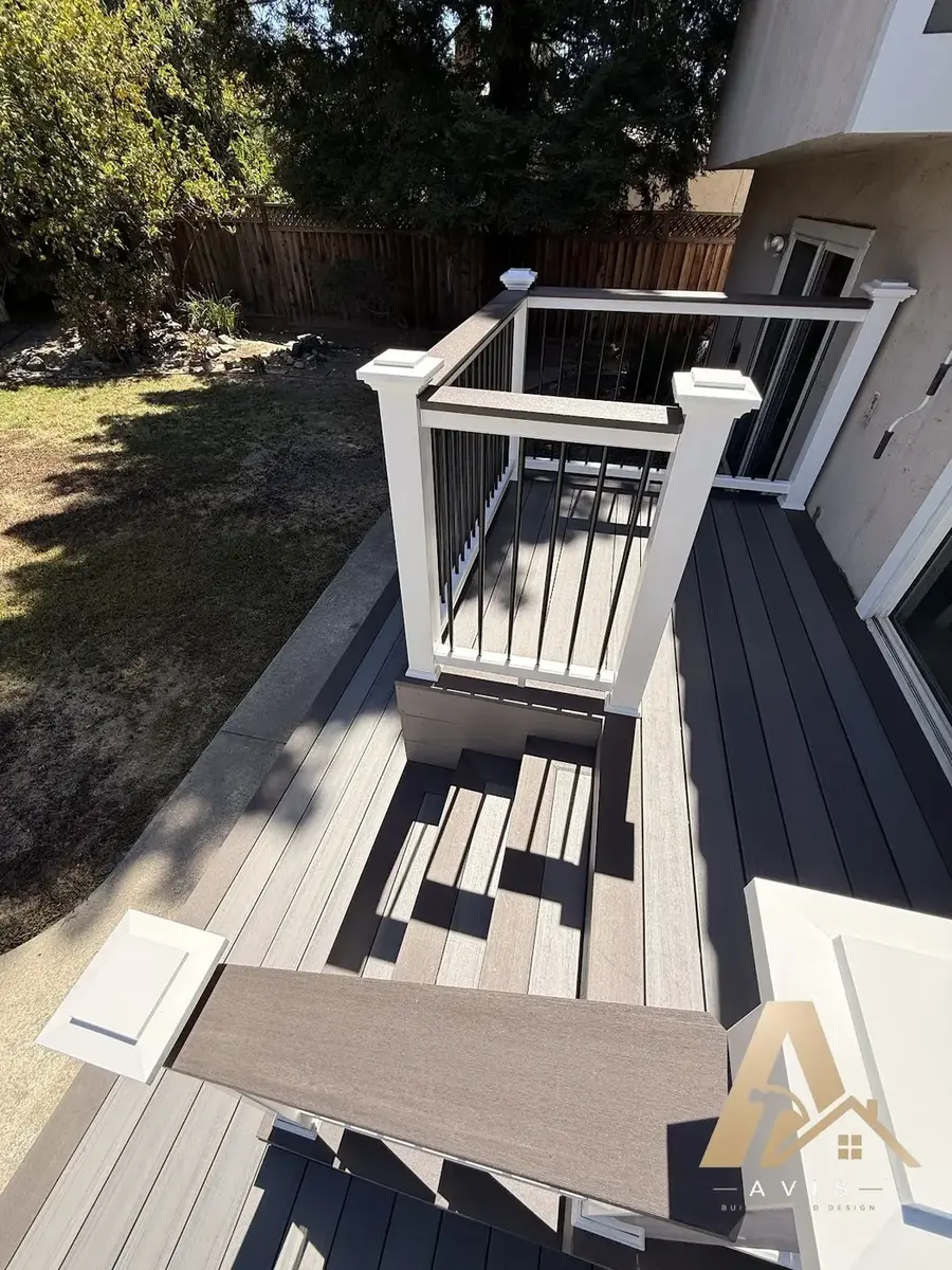 Built-in composite bench beside railing with post cap lighting