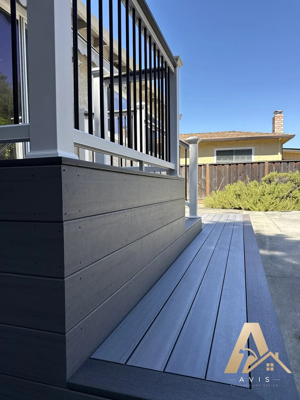 Gray composite deck with white posts and black balusters