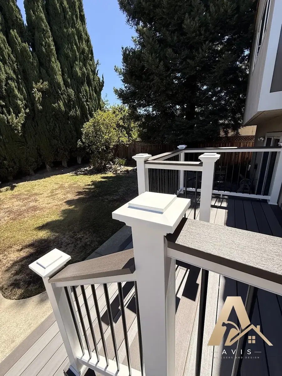 Composite deck and railing with cypress trees along the yard