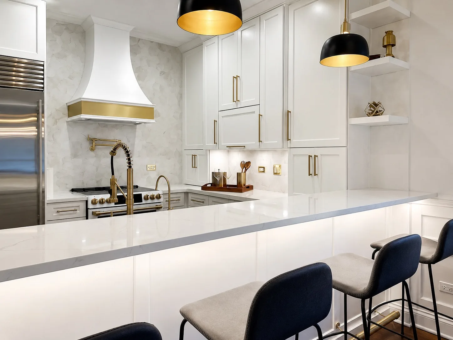 White kitchen peninsula with quartz counters and bar stools